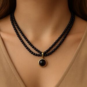 Fire Agate pendant on double strand black beads 18” long